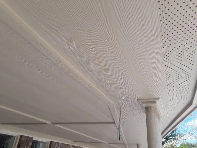 Close view of a vented soffit panel with a wood-grain texture