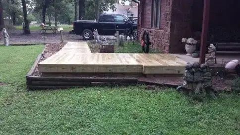 A wooden platform path across a yard